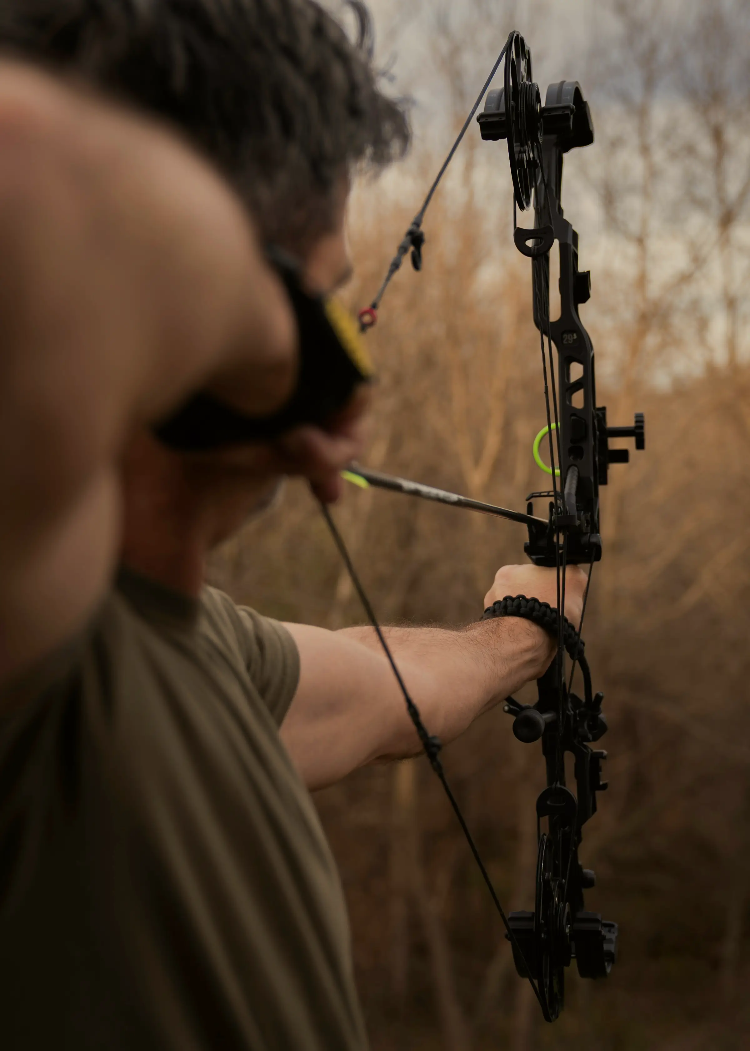 An archer drawing a compound bow